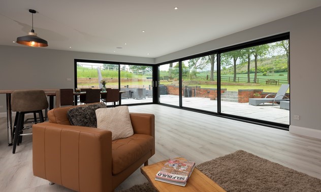 interior shot of black aluminium sliding doors in living room with sofa
